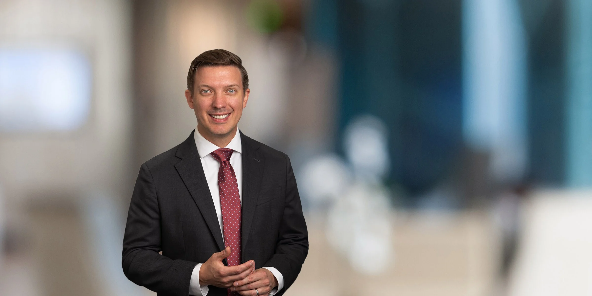 Ben Wills in a black suit and red tie