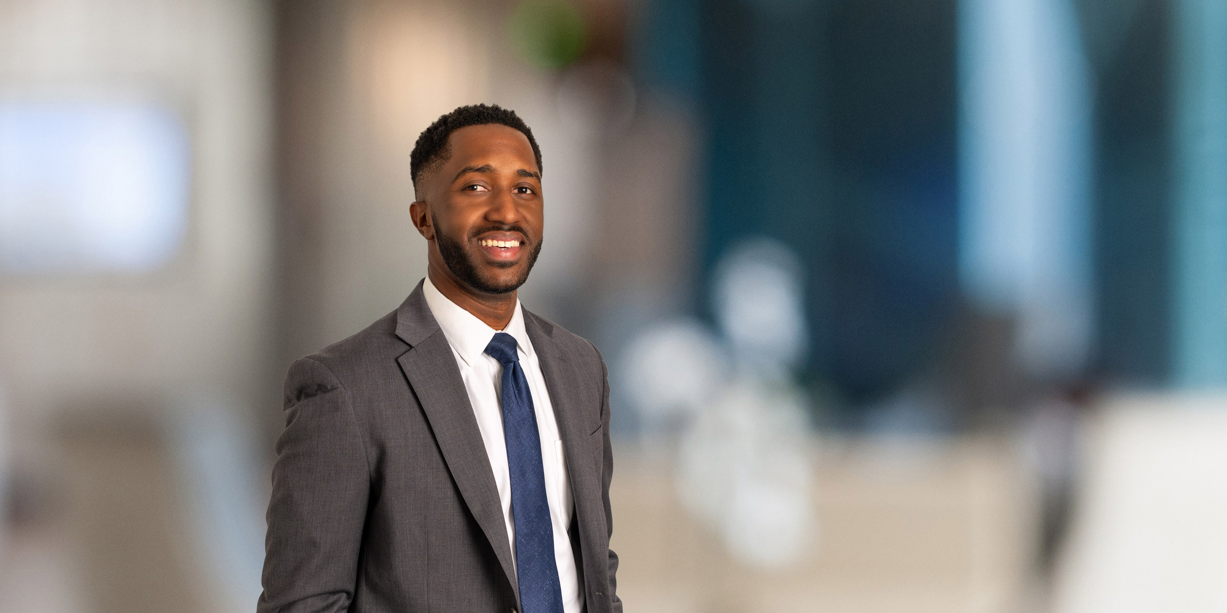 Will Palmer in a dark suit and blue tie