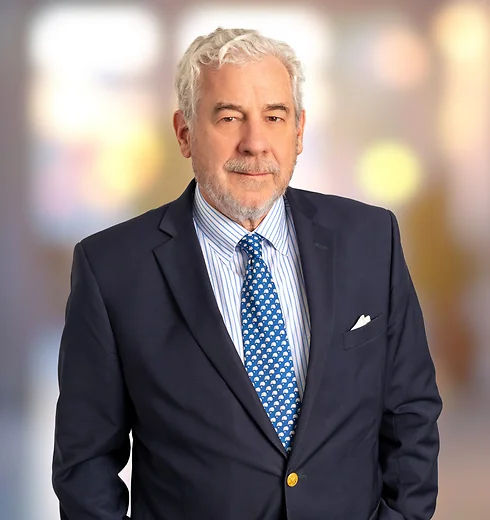 Paul Gerhardt in dark suit and patterned tie