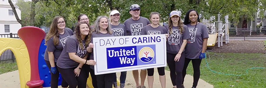 Group of people holding up a Day of Caring sign