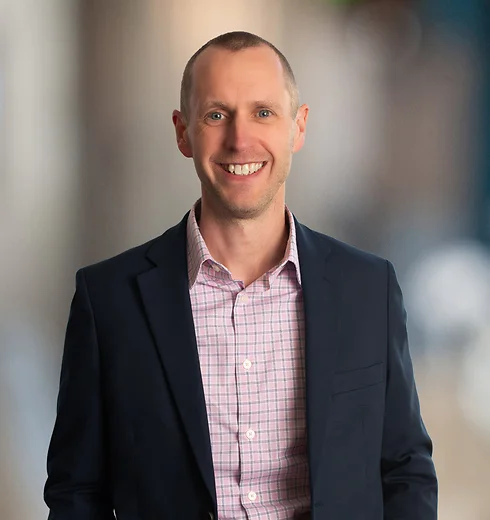 Smiling Rob Johnson in a suit