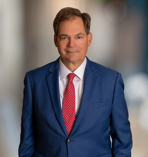 Smiling Greg Davis in a suit