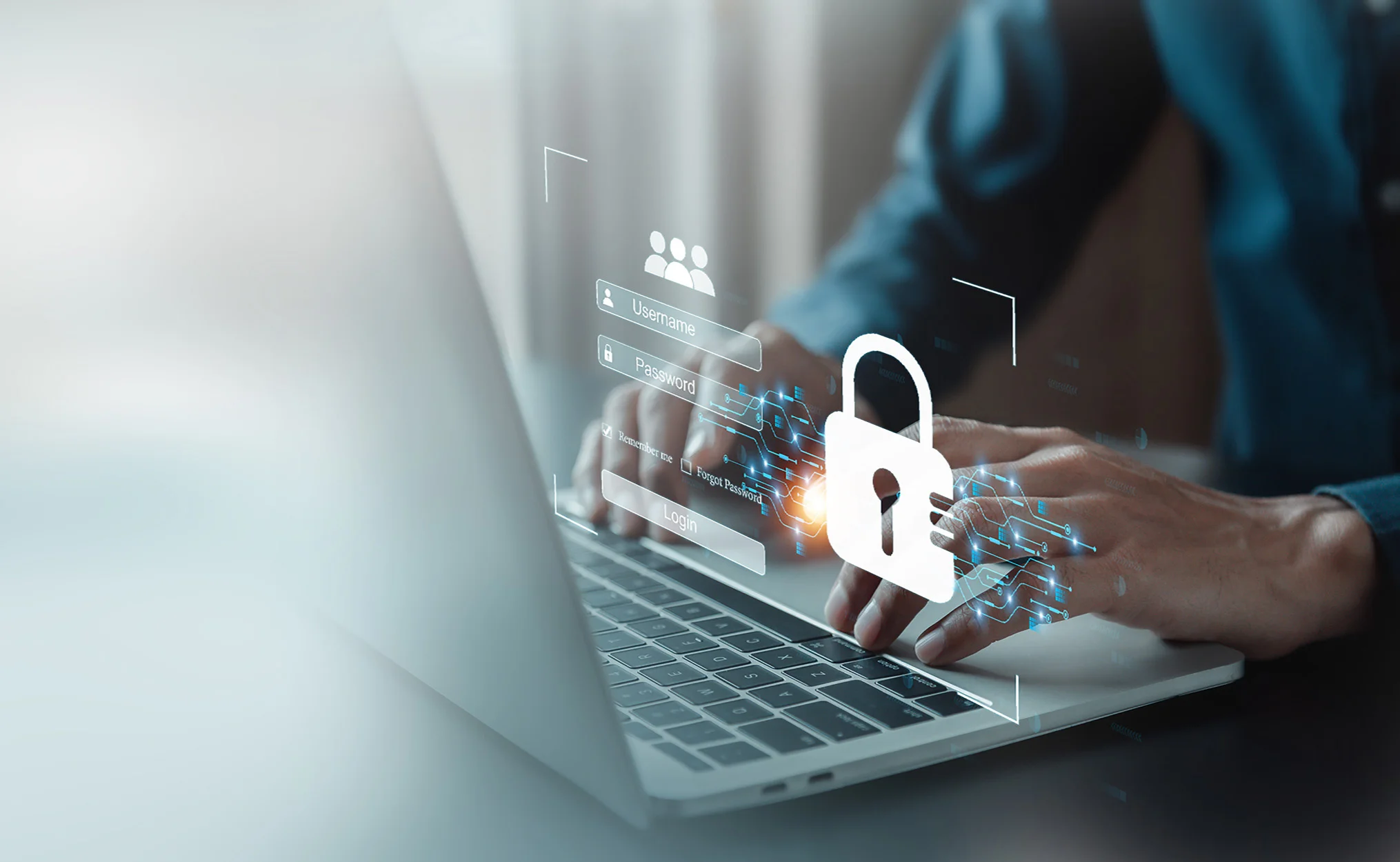 Hands typing on a laptop with cyber images floating above it