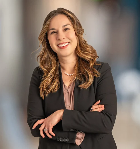 Alisha Wisener smiling in a dark suit and light pink top
