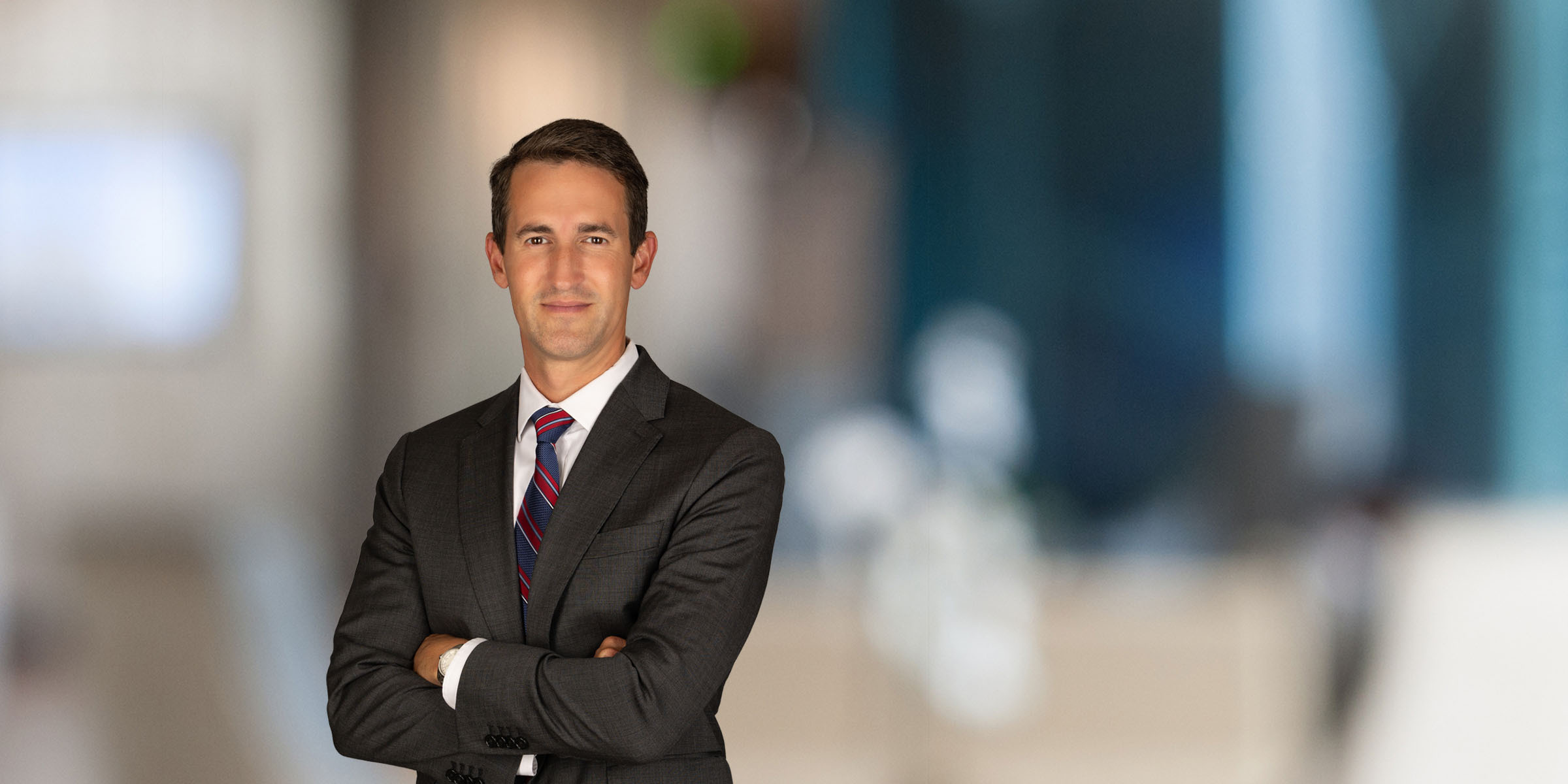 Joe Houchin in a suit with his arms crossed