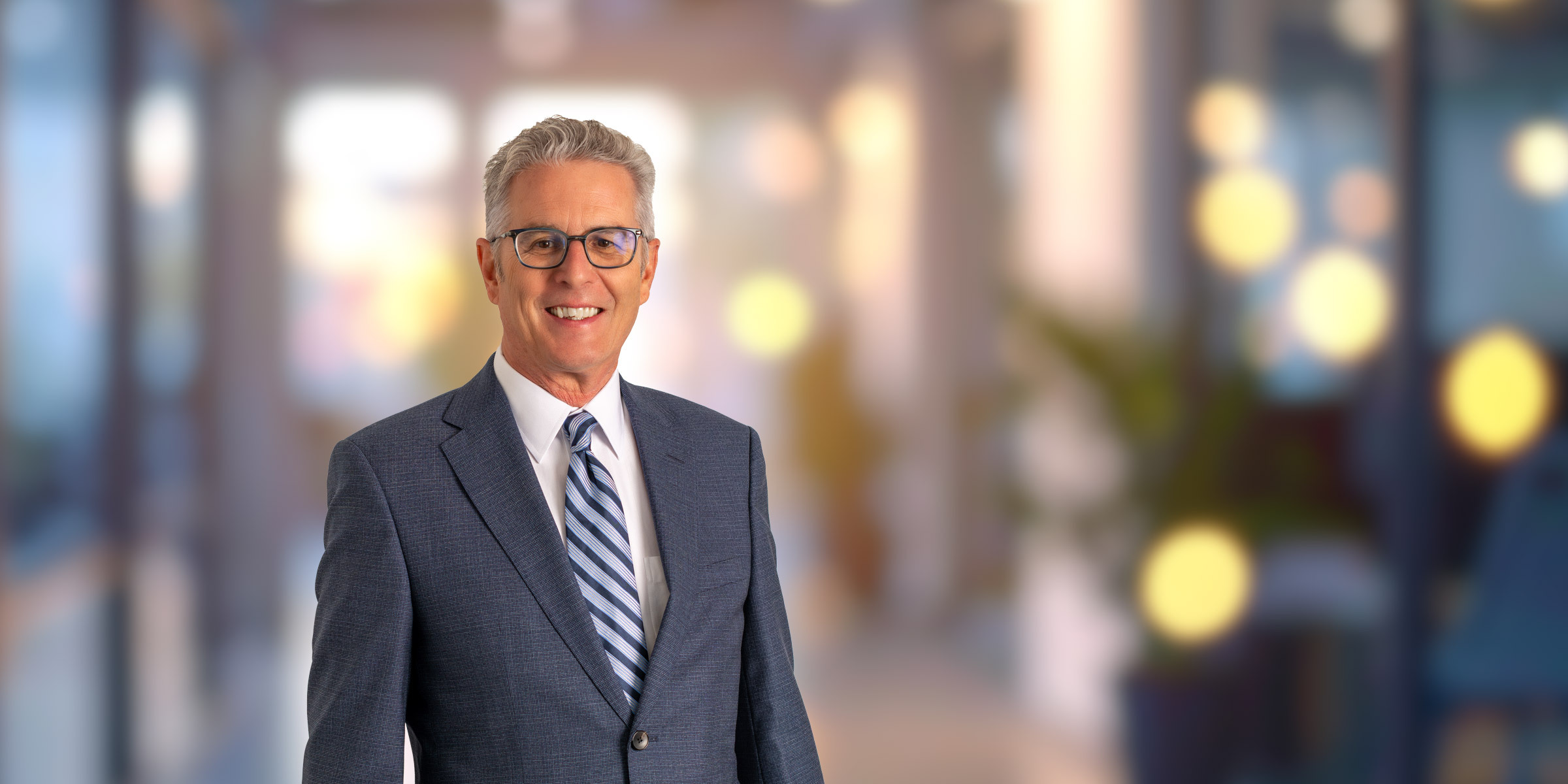 David Delpierre in blue suit and striped tie