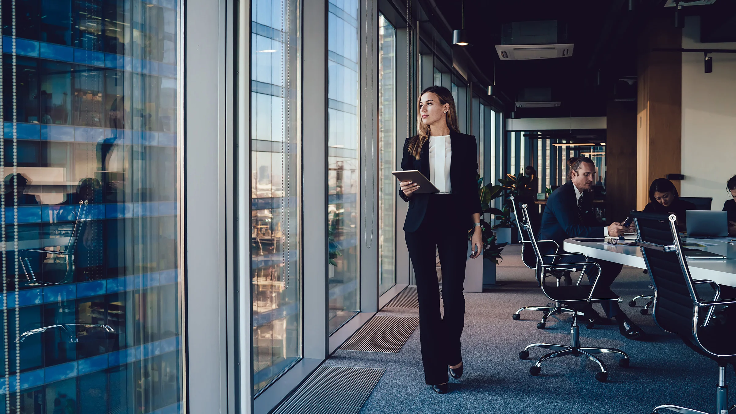 Woman in office looking out window