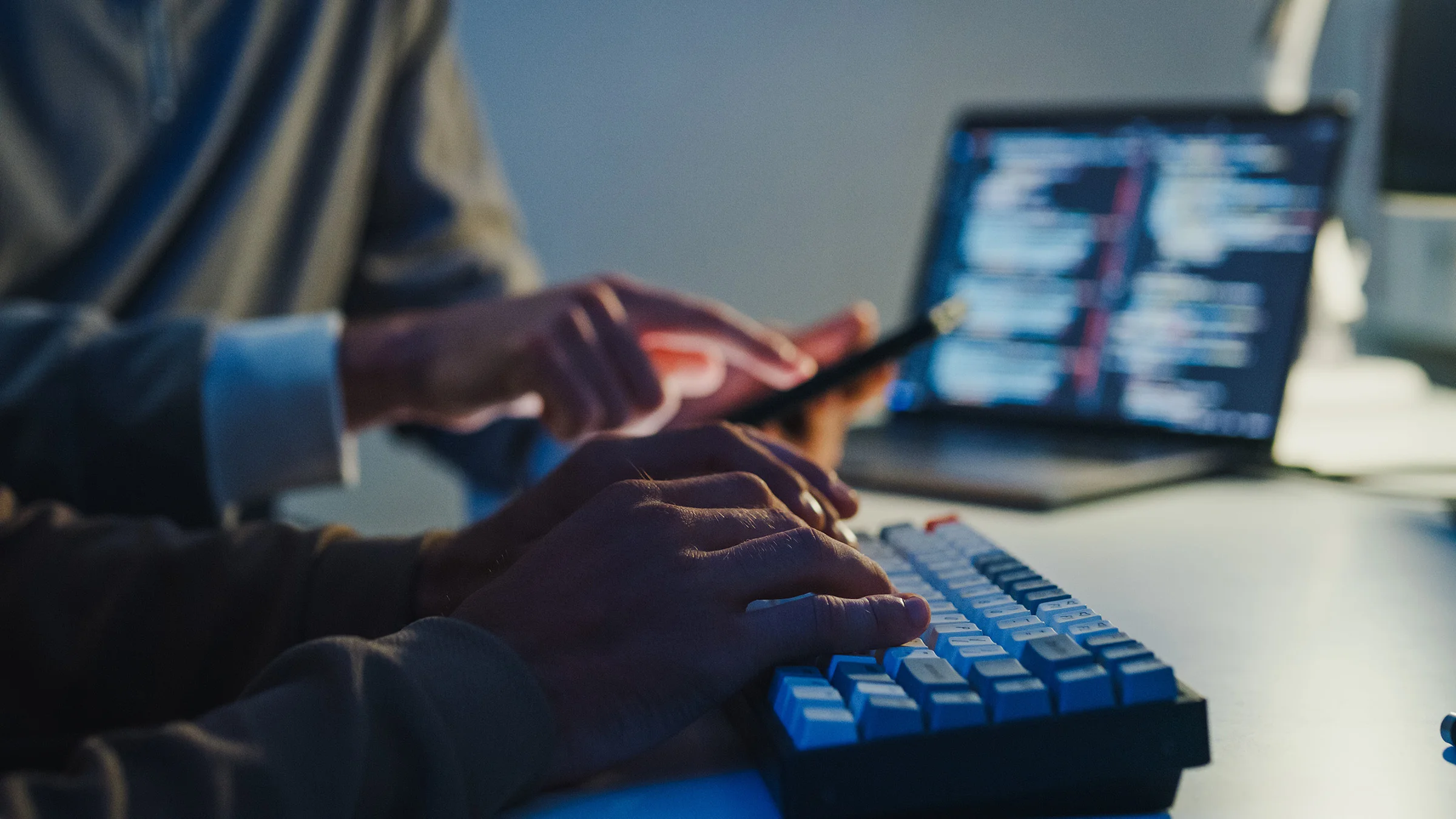 2people typing and pointing at a cell phone