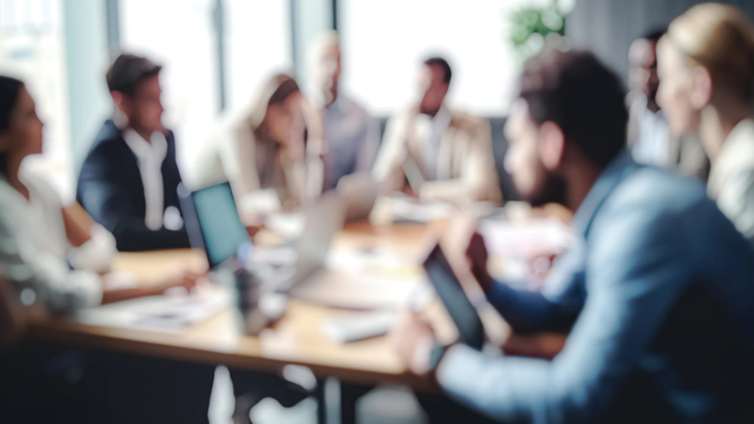 Blurred group of people around a conference table