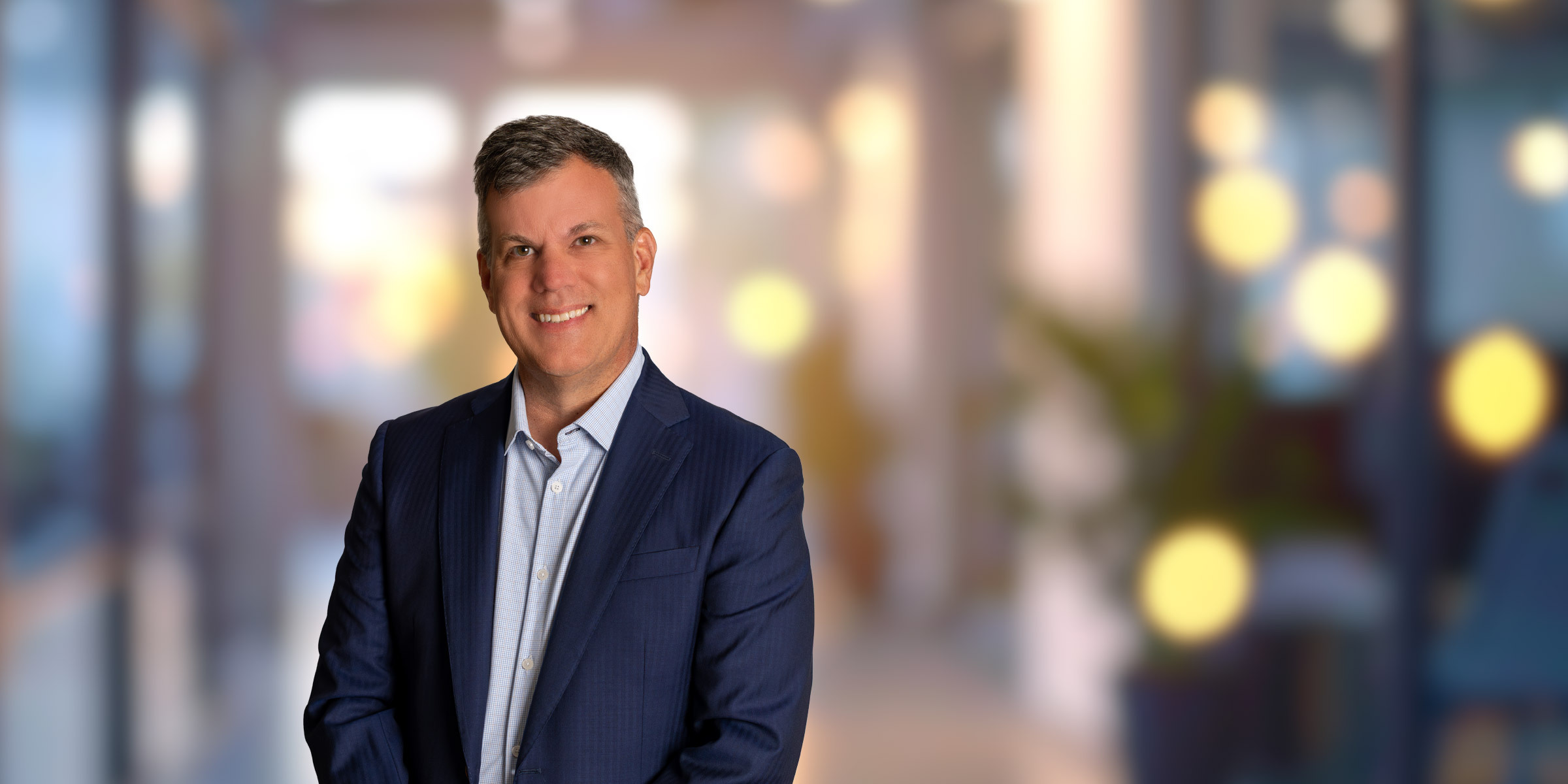 Alex Powell in a dark blue suit