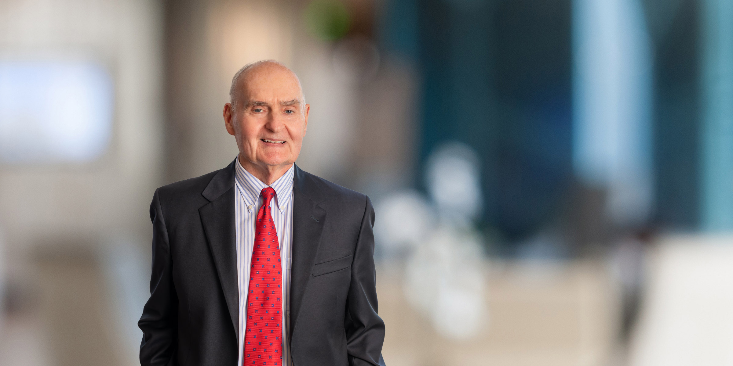 Conway Sheild smiling while wearing a business suit