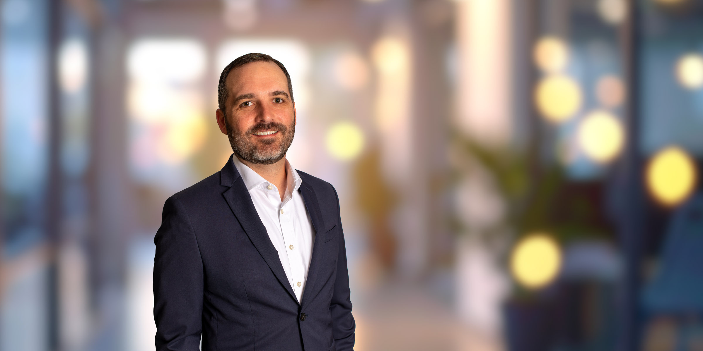 Smiling Christopher McLean in a suit