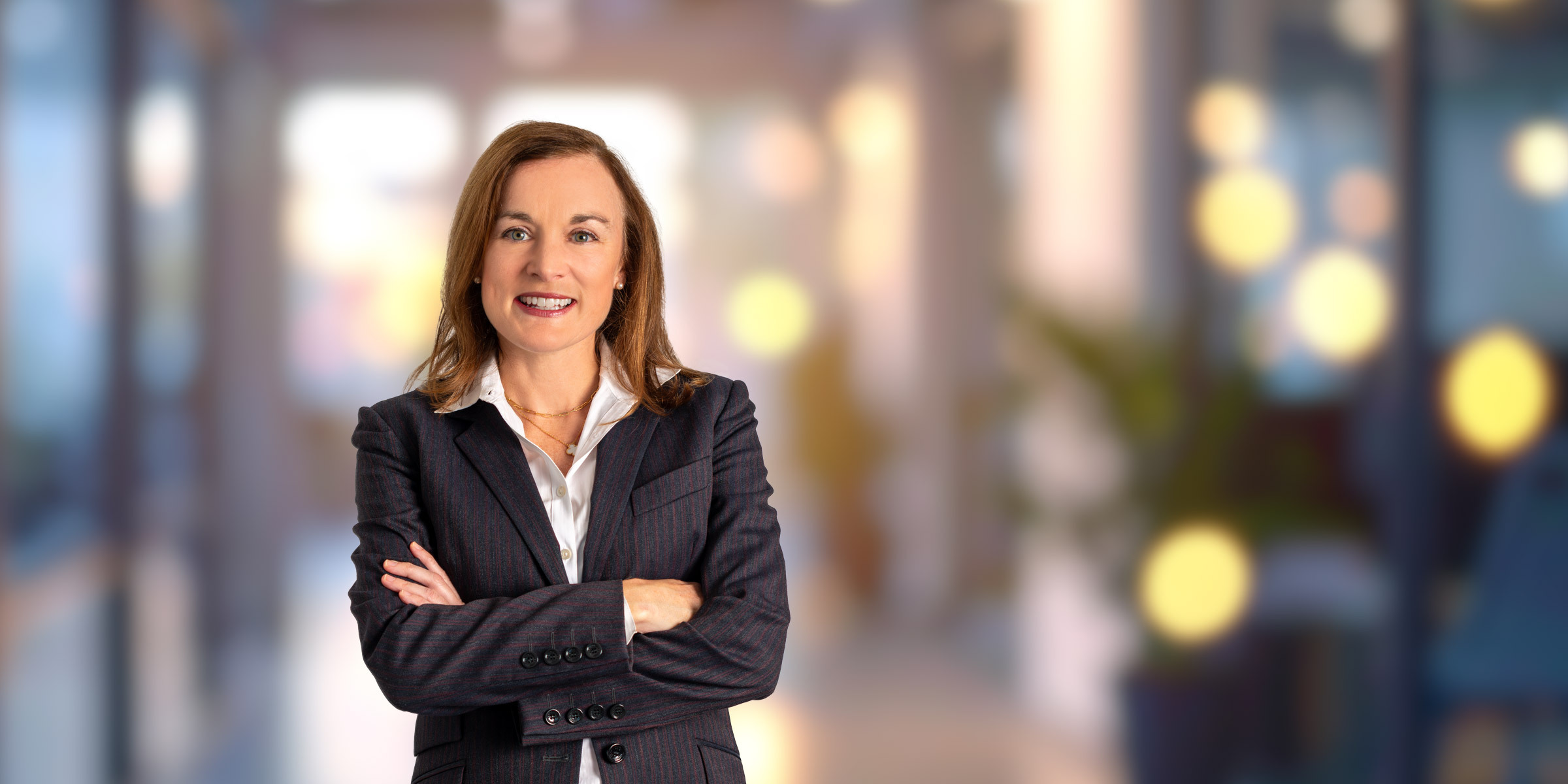 Mary Beth smiling wearing a dark striped suit