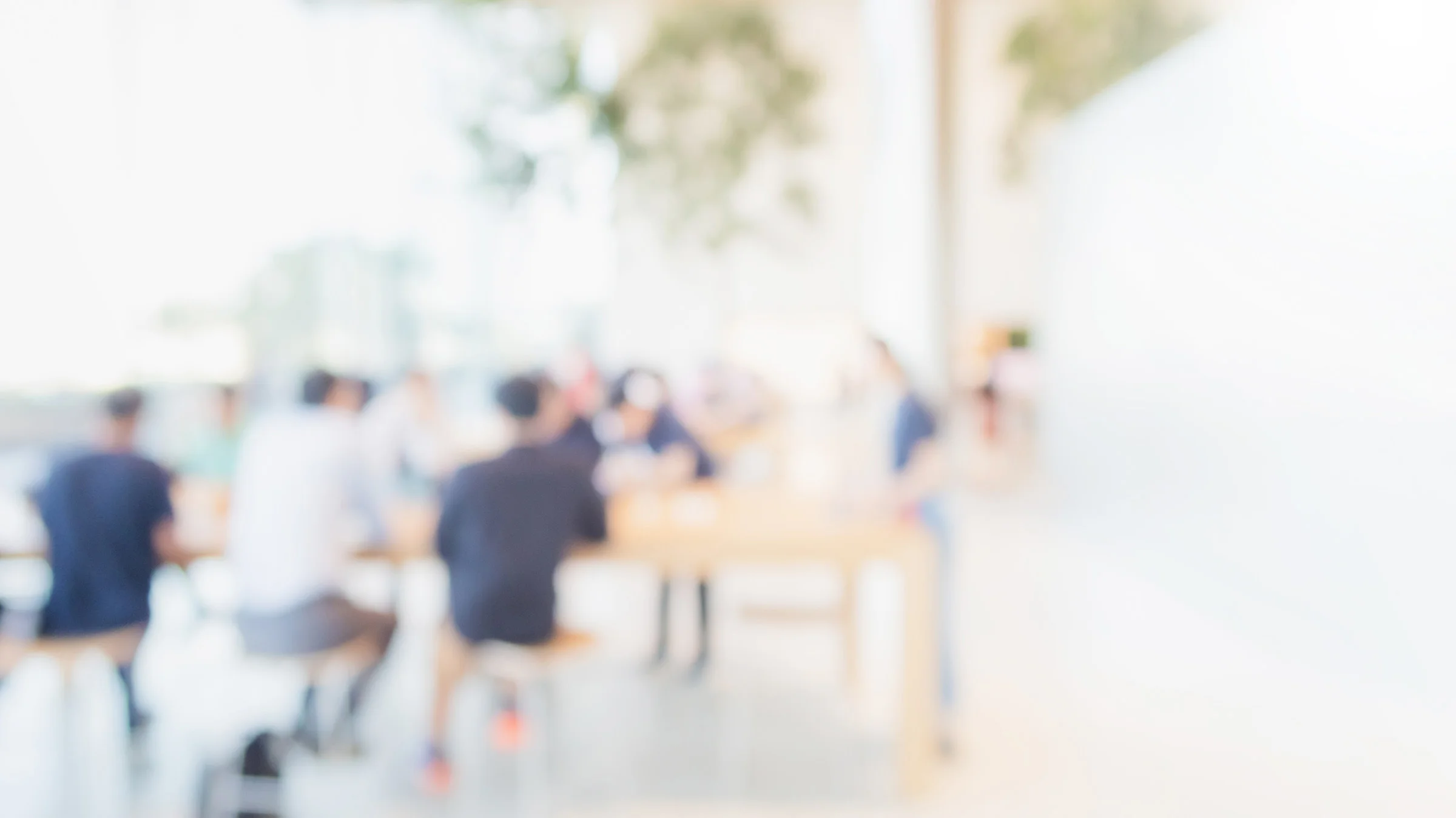 Blurred people sitting around a table