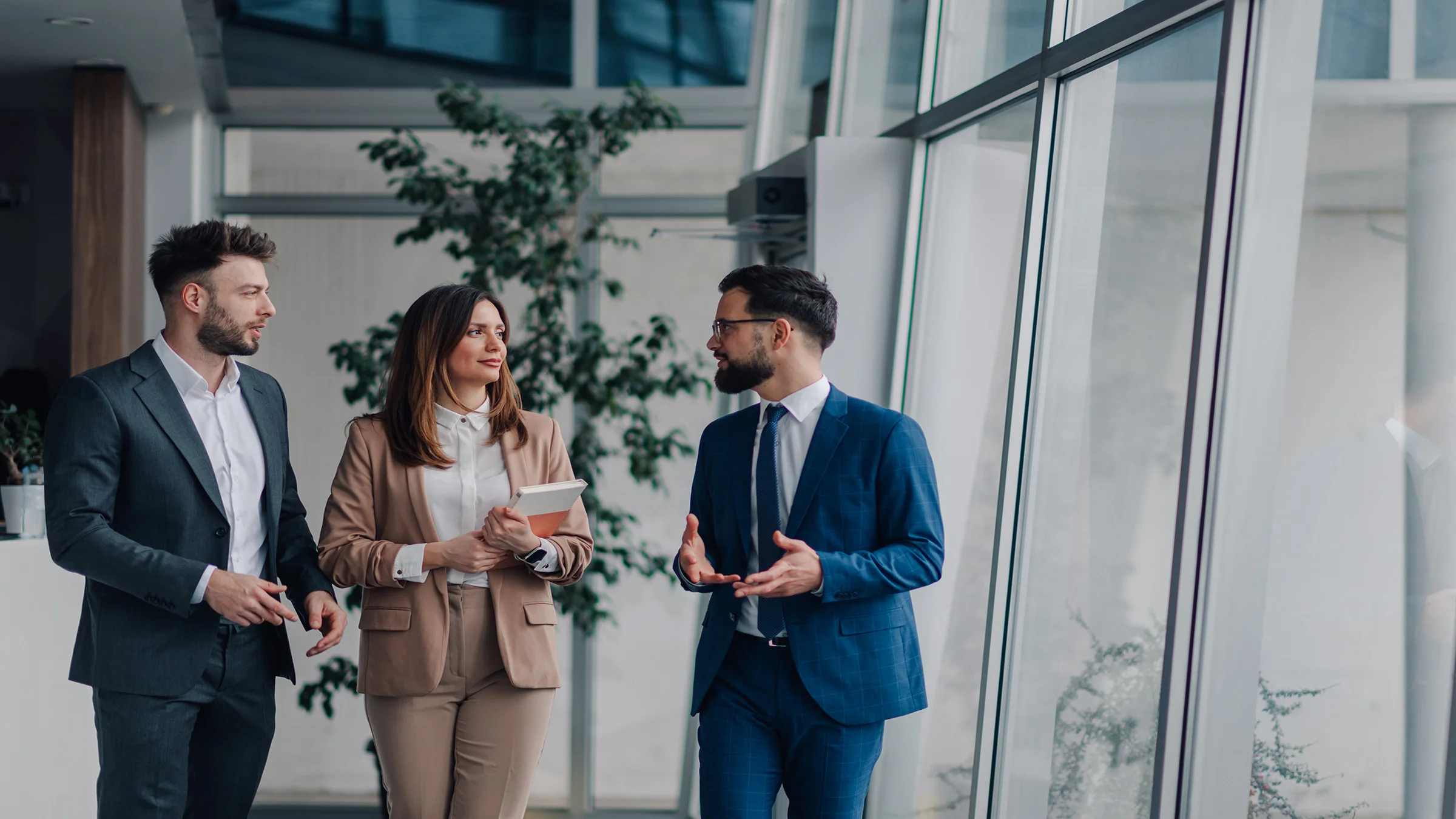 3 business people standing in a business labby