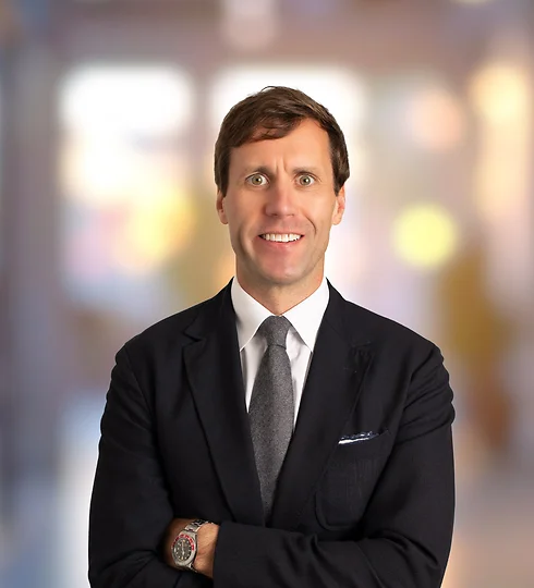 Britton Williston smiling in a dark suit