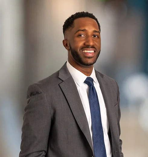 Will Palmer in a dark suit and blue tie