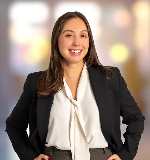Maeve Harris in a suit with her hands on her hips