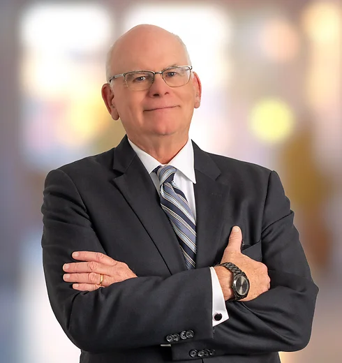John Holloway in dark suit and striped tie