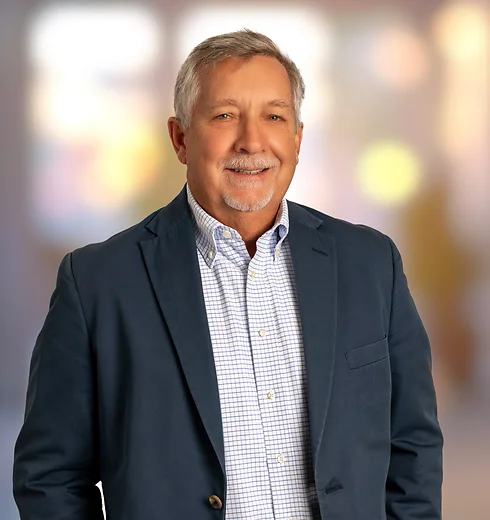 Rik Mapp in a light shirt and dark suit jacket