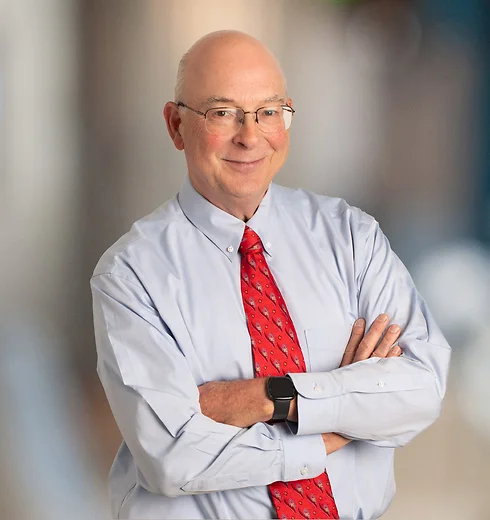Steve Story wearing a light blue shirt and red tie