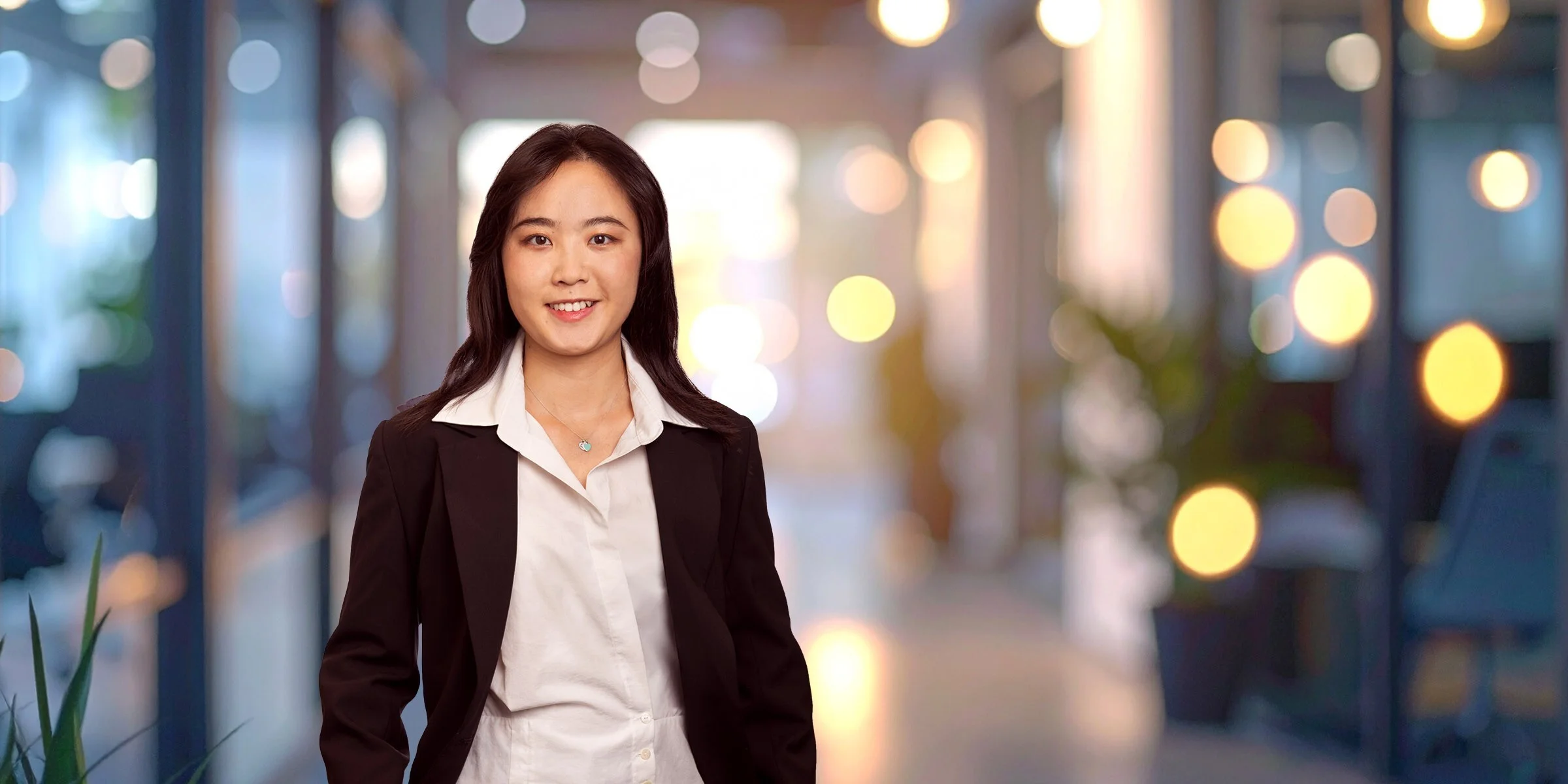 Scarlett Shuai in dark suit jacket and blouse