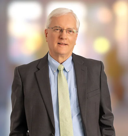 Barry Hunter in dark suit and yellow tie