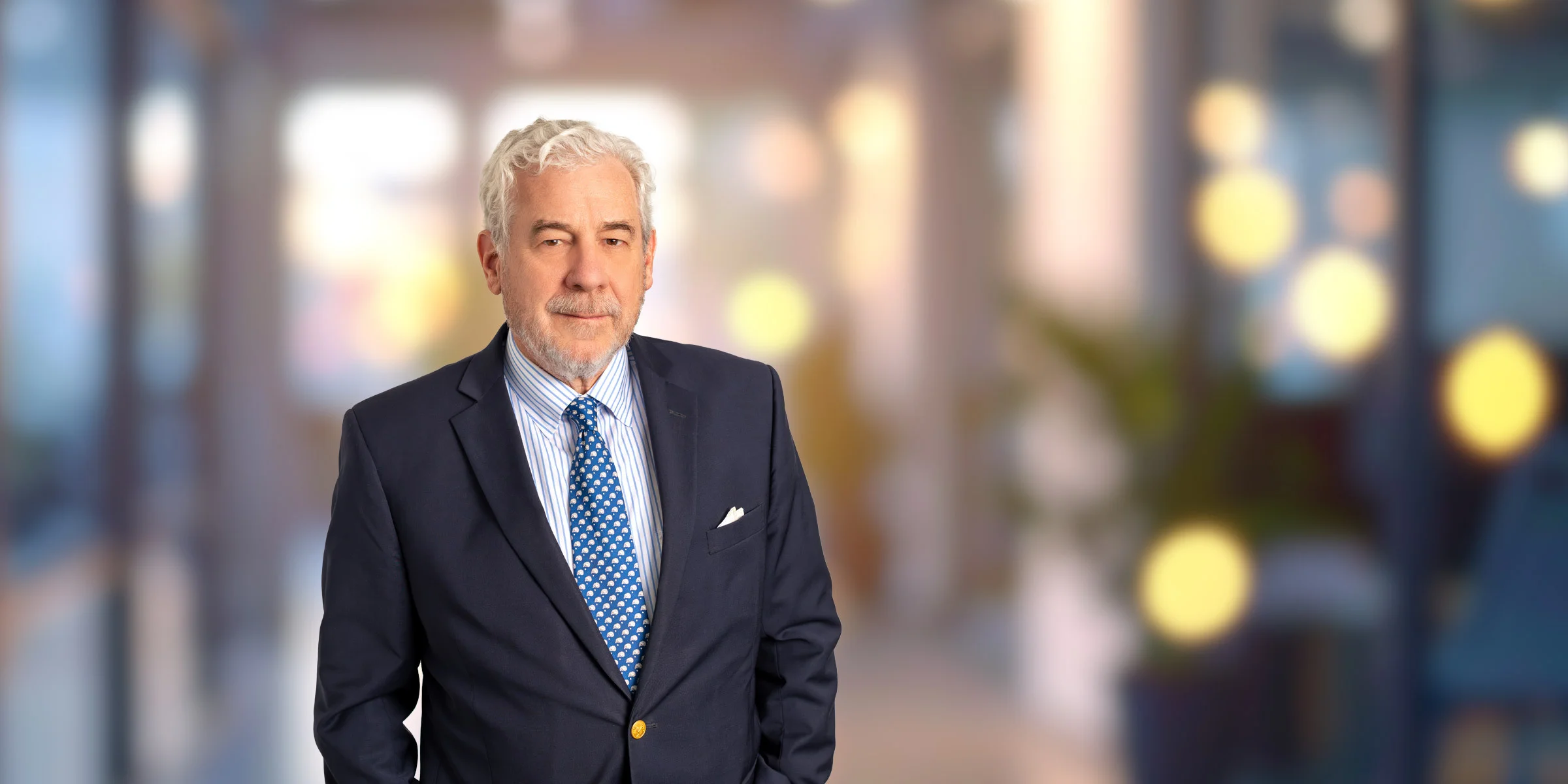 Paul Gerhardt in dark suit and patterned tie