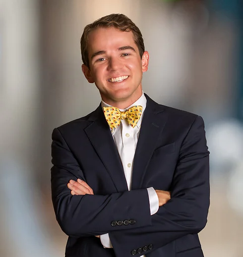 John Pittman in a dark suit and yellow bowtie