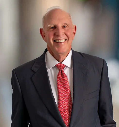 Rob Goodman smiling in a suit