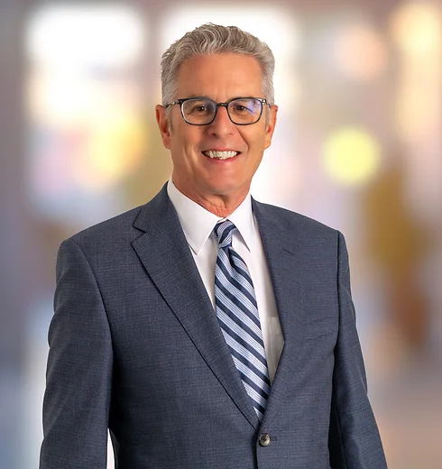 David Delpierre in blue suit and striped tie