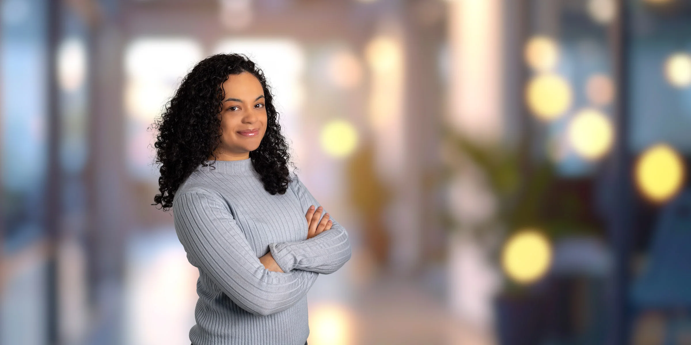 Journey Matos in a light blue sweater with her arms crossed