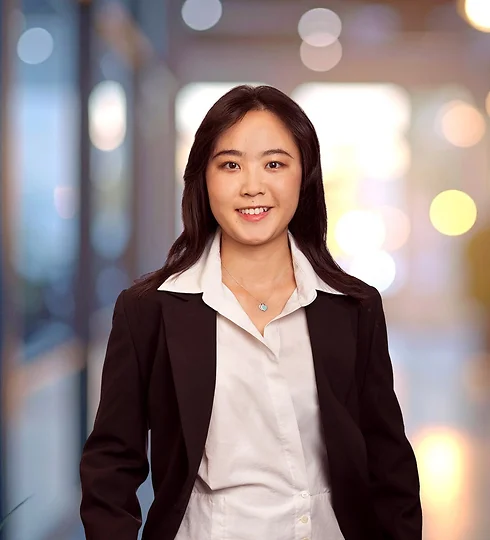 Smiling Scarlett Shuai in a white top and black jacket