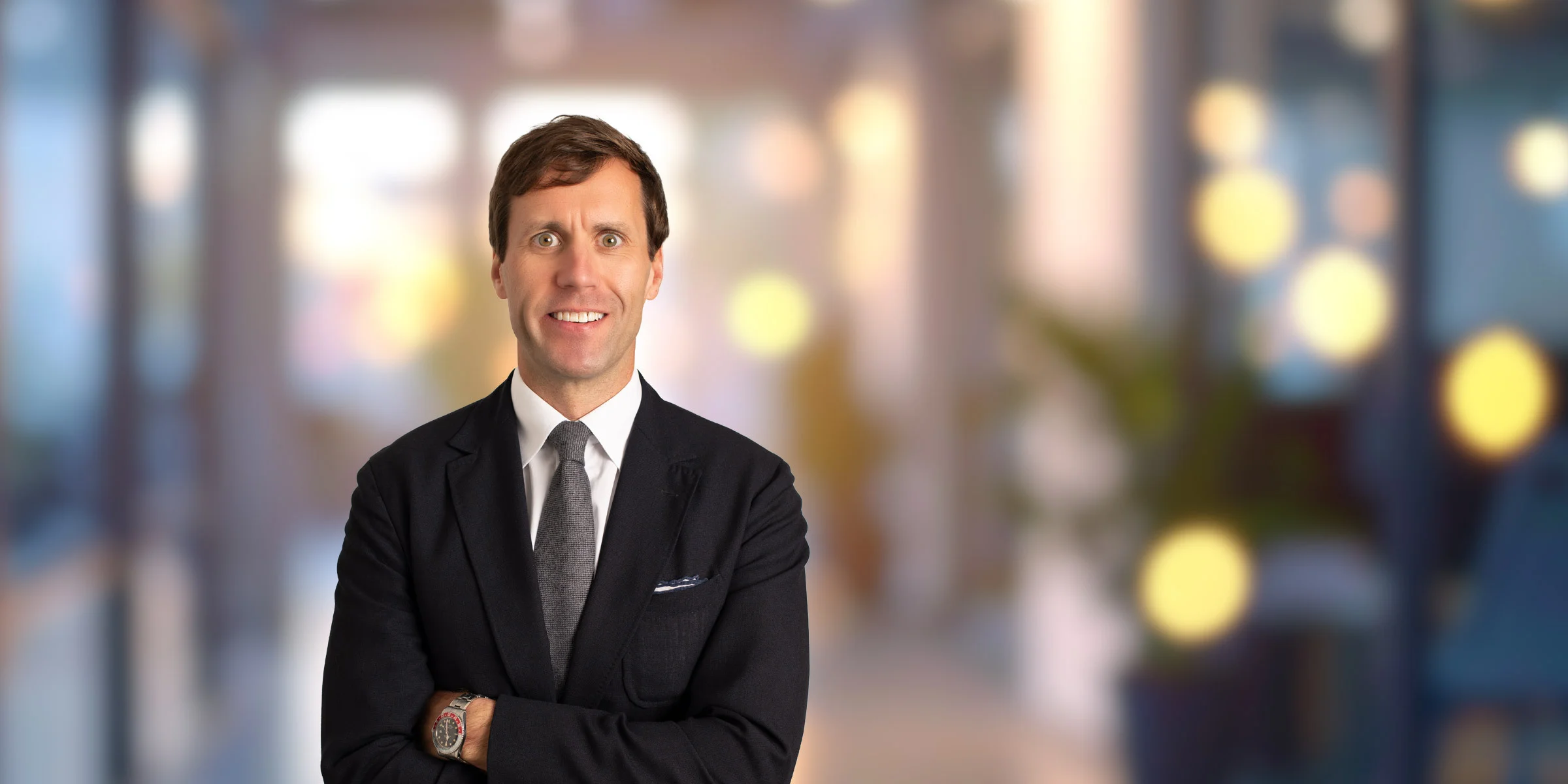 Britton Williston smiling in a dark suit