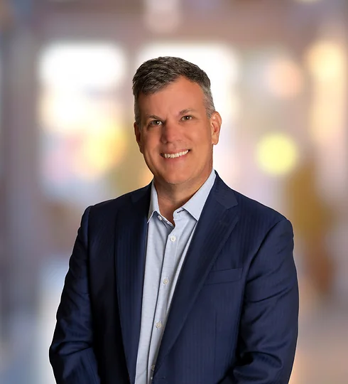 Alex Powell in a dark blue suit