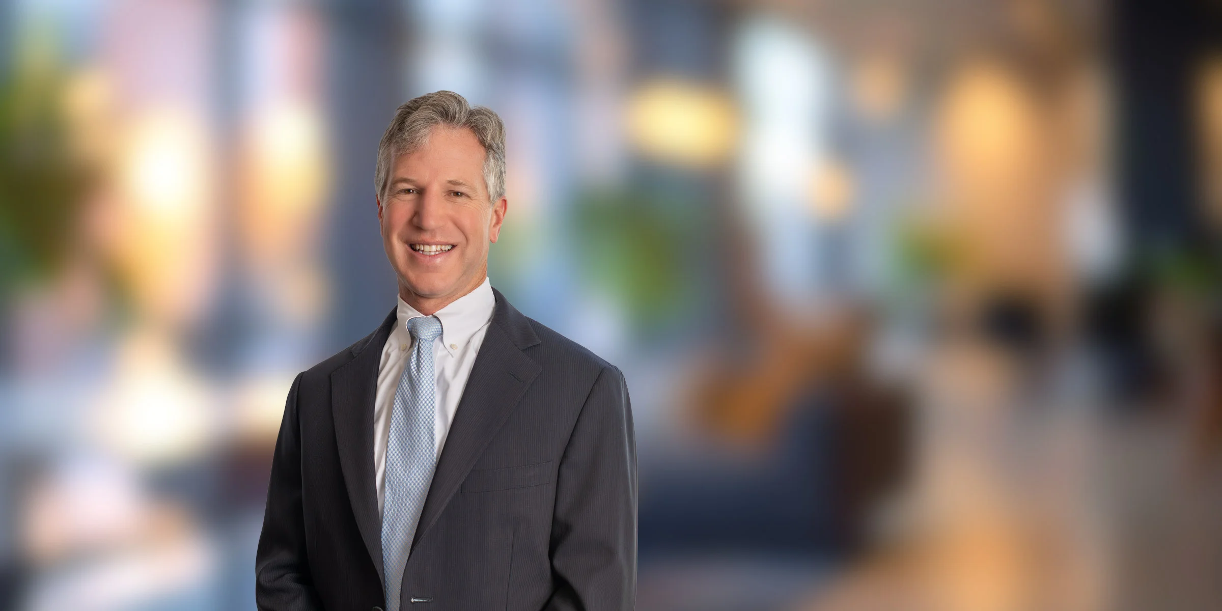 Timothy Trant in dark suit and blue tie