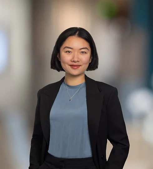 Jenny Wang in a black suit and light blue shirt