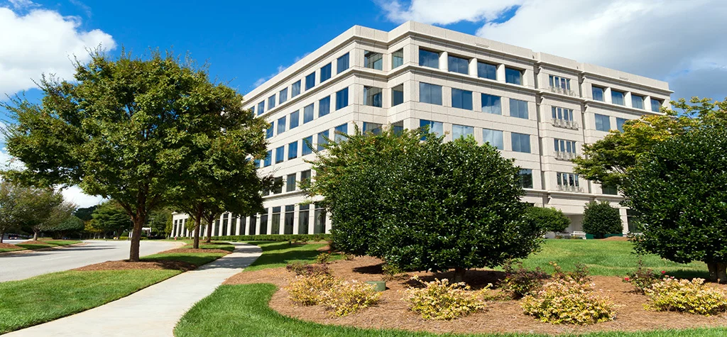 White building with tress nearby
