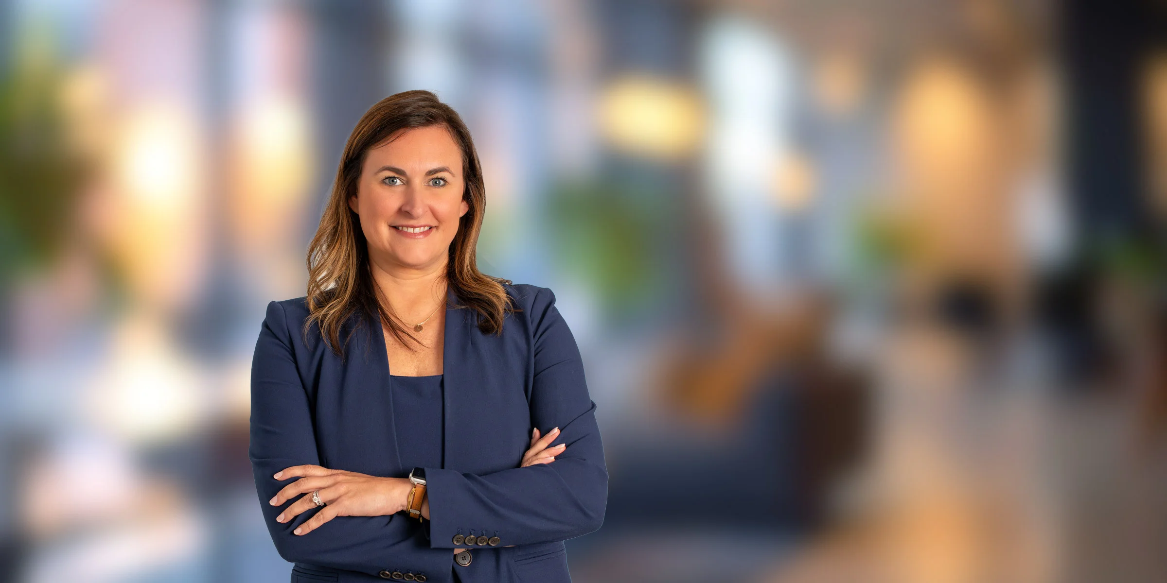 Lauren Kadish in a suit with her arms crossed