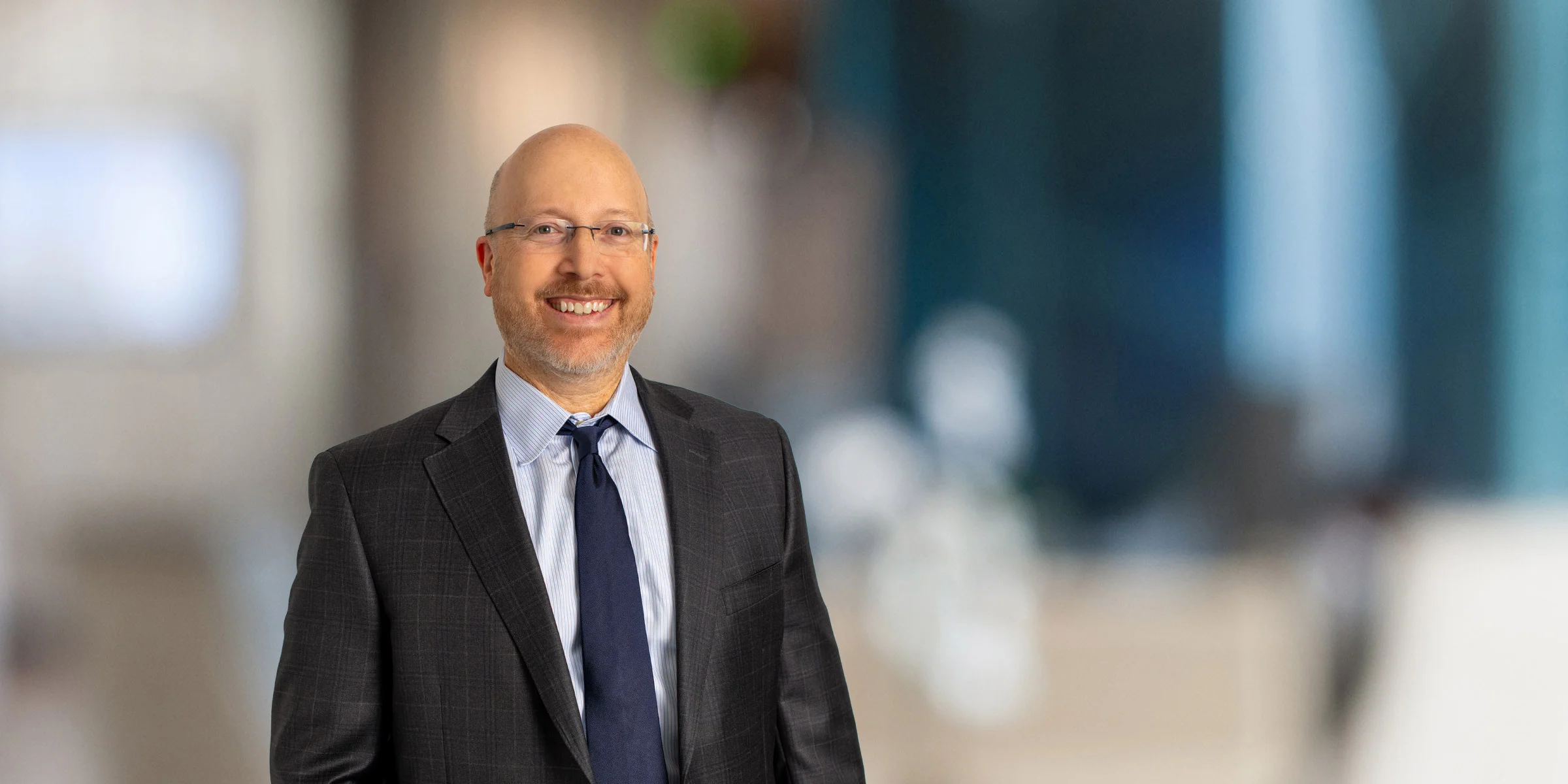 David Kamer in dark suit and navy tie