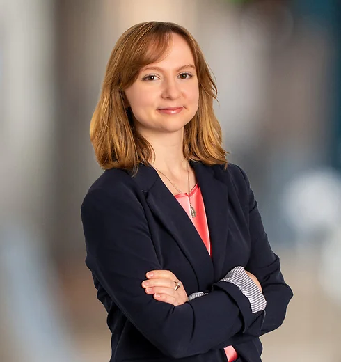 Savannah Kimble smiling in a pink shirt and suit jacket with her arms crossed