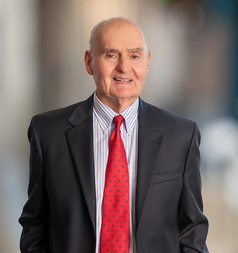 Conway Sheild smiling while wearing a business suit