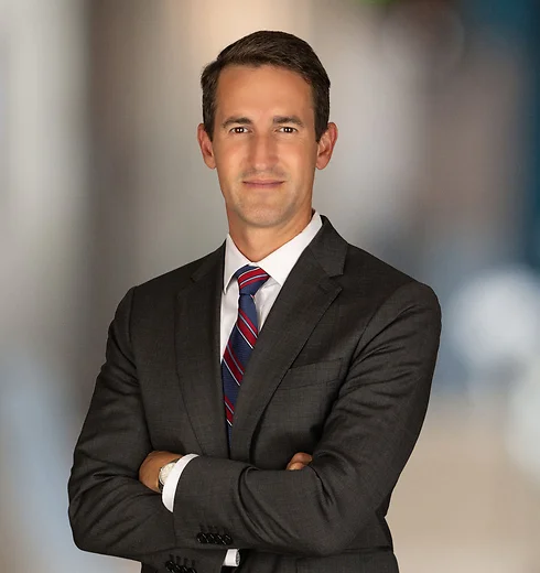 Joe Houchin in a suit with his arms crossed