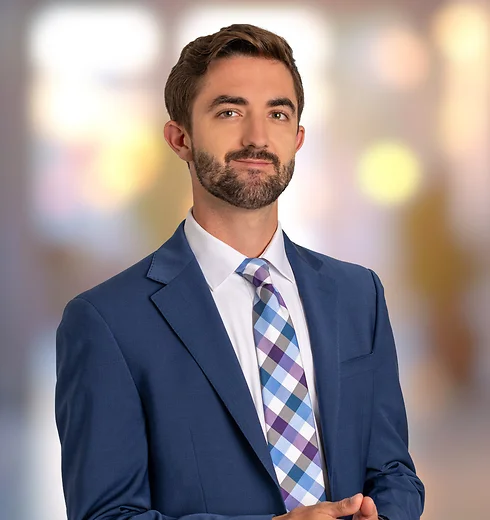 Jackson Martingayle in blue suit and plaid tie