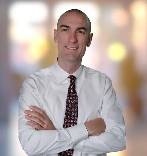 Tony Basch in a white shirt and maroon tie