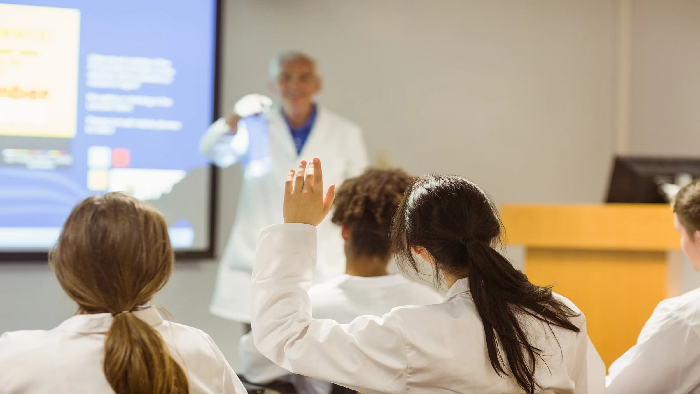 Doctor in classroom teaching med students