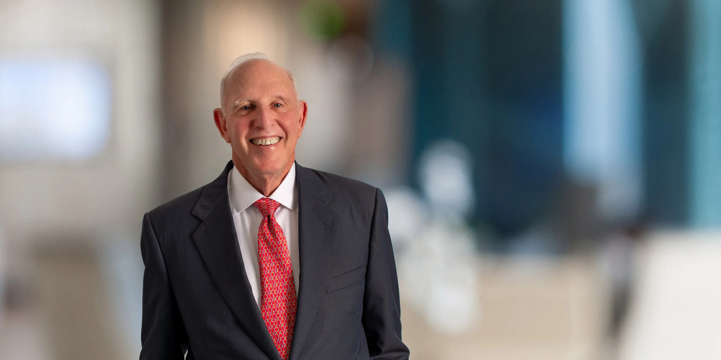 Rob Goodman smiling in a suit