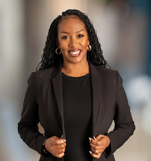 Smiling Nia Lissimore wearing a black suit