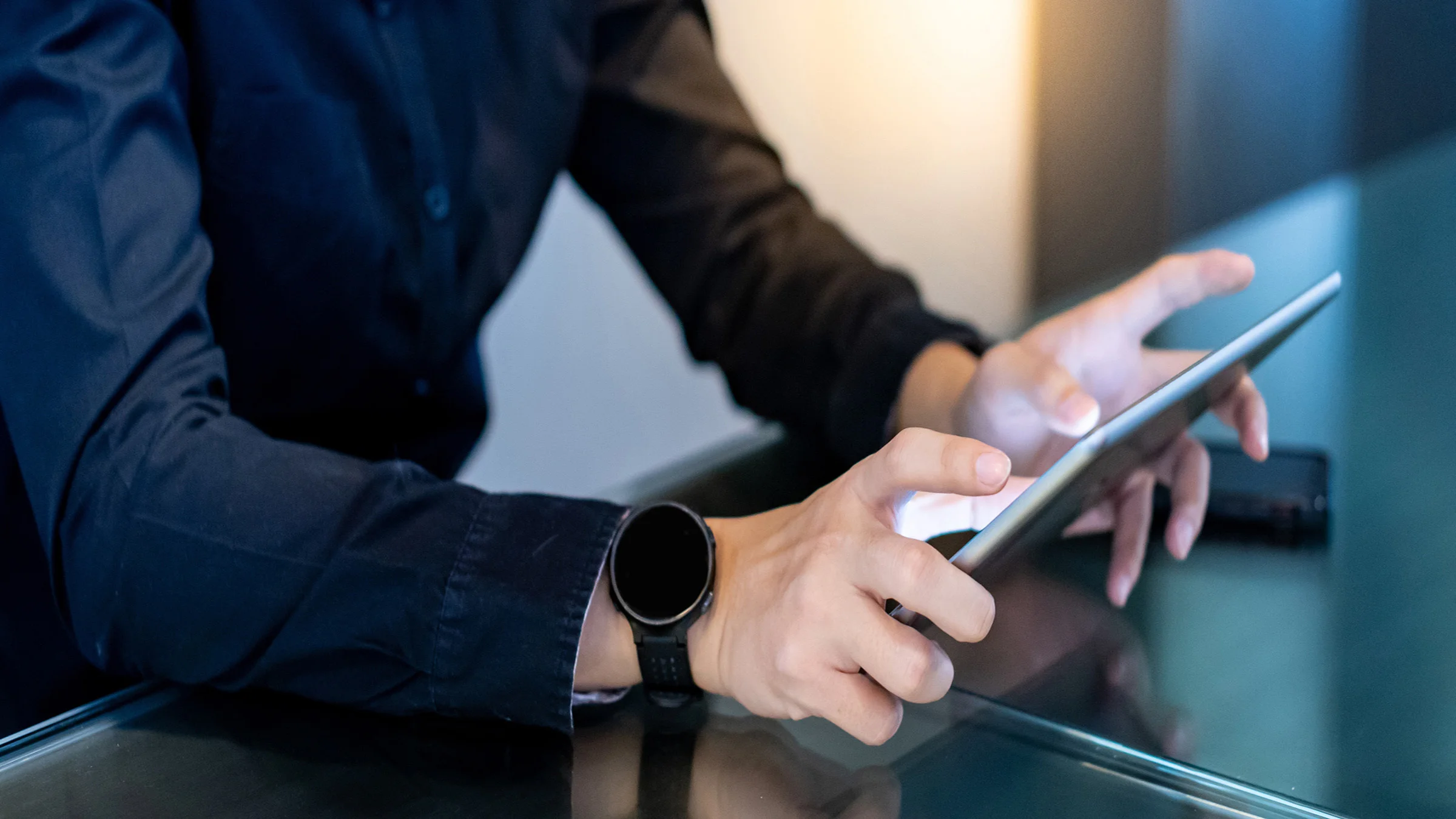 Man in dark blue shirt holding tablet