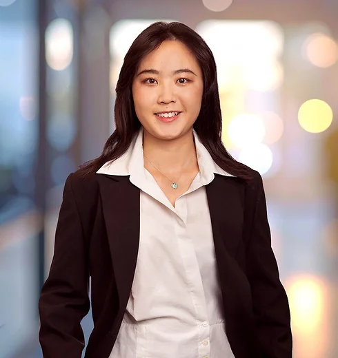 Scarlett Shuai in dark suit jacket and blouse
